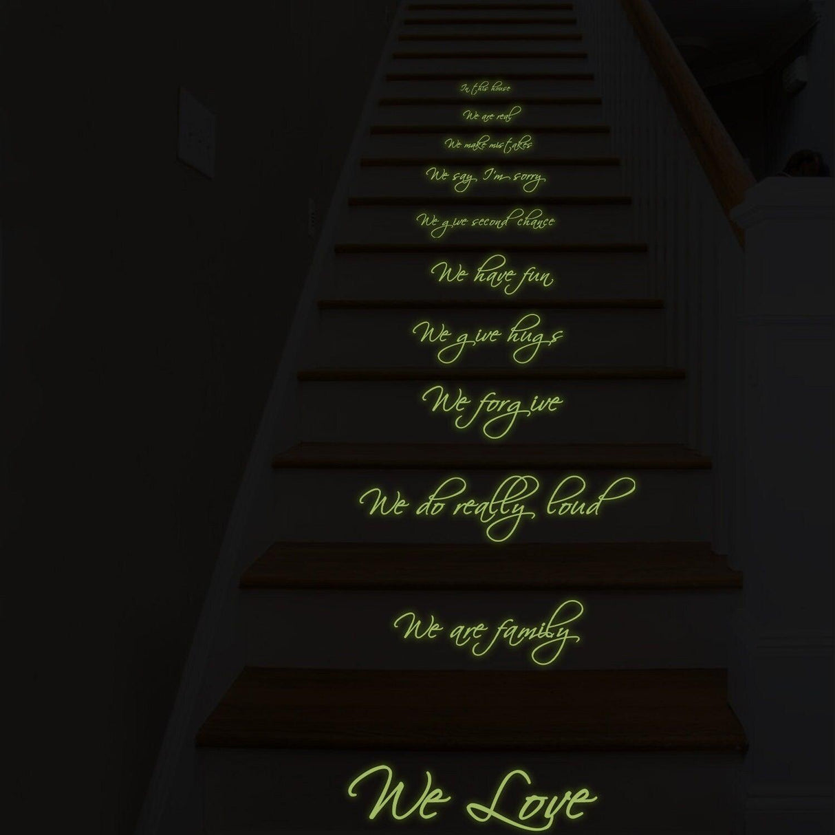 Glow in the dark vinyl stair sticker with family quotes on wooden staircase, enhancing home decor.