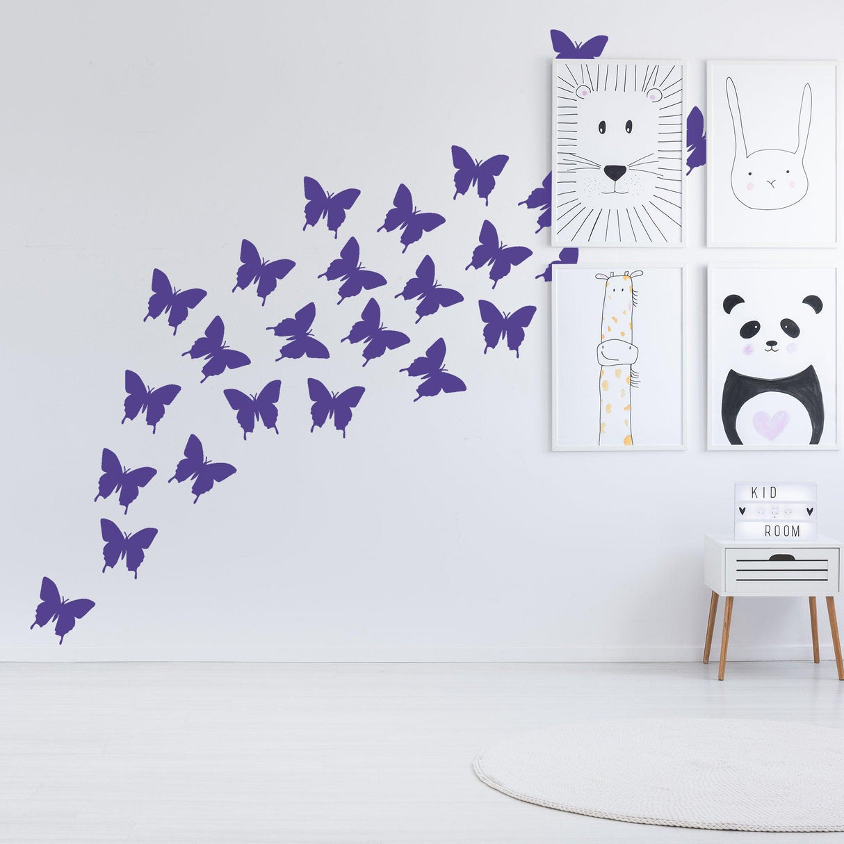 Purple butterfly wall stickers in a whimsical arrangement, adding charm to a kids' room with animal art decor.