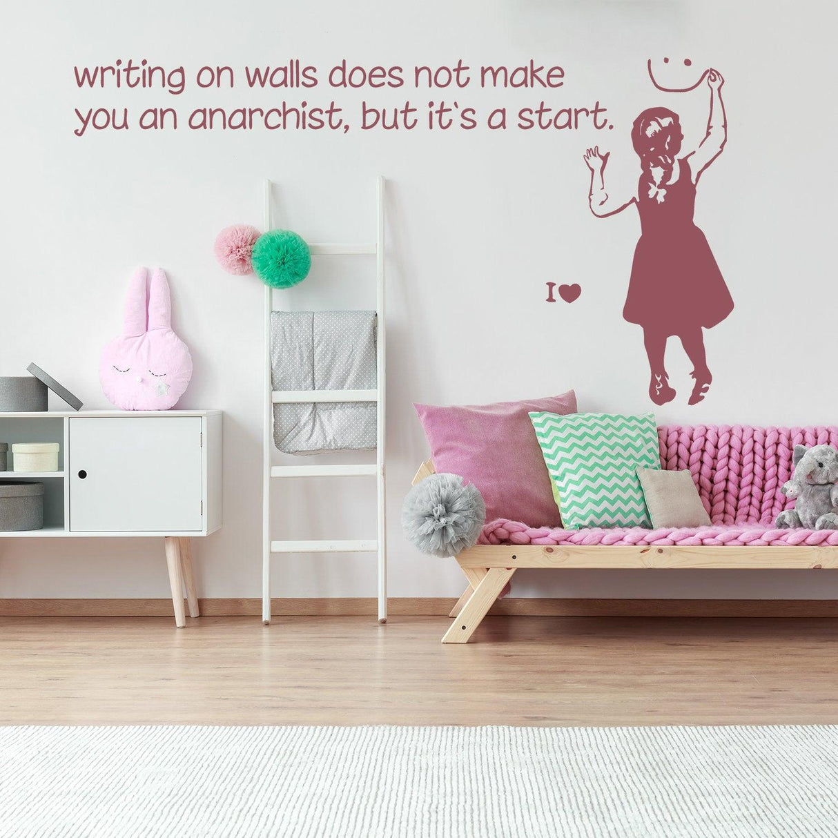 Banksy-inspired wall sticker with girl and quote about anarchism in stylish room decor.
