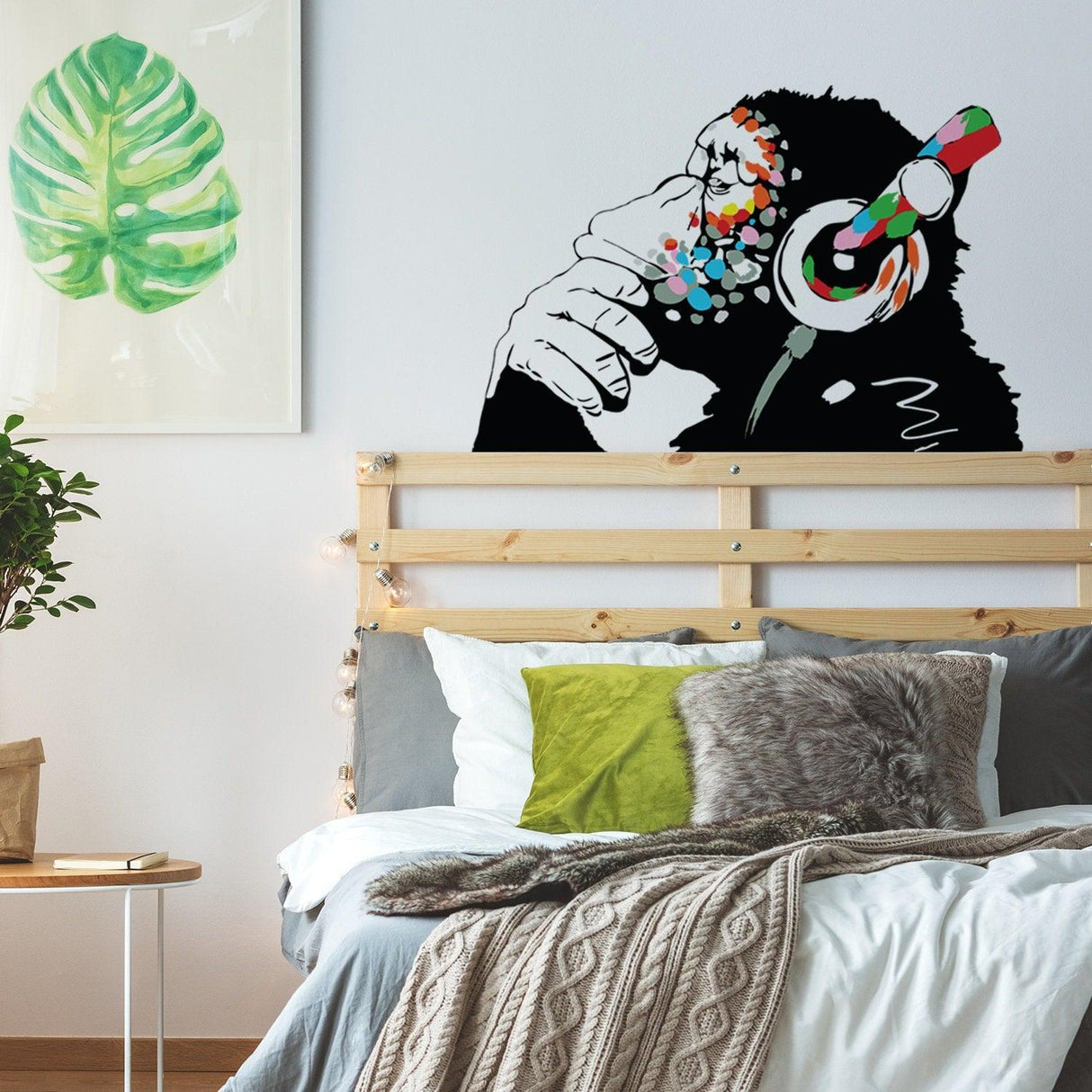 Wall art featuring a monkey with headphones in a stylish bedroom setting, adding a fun touch to home decor.