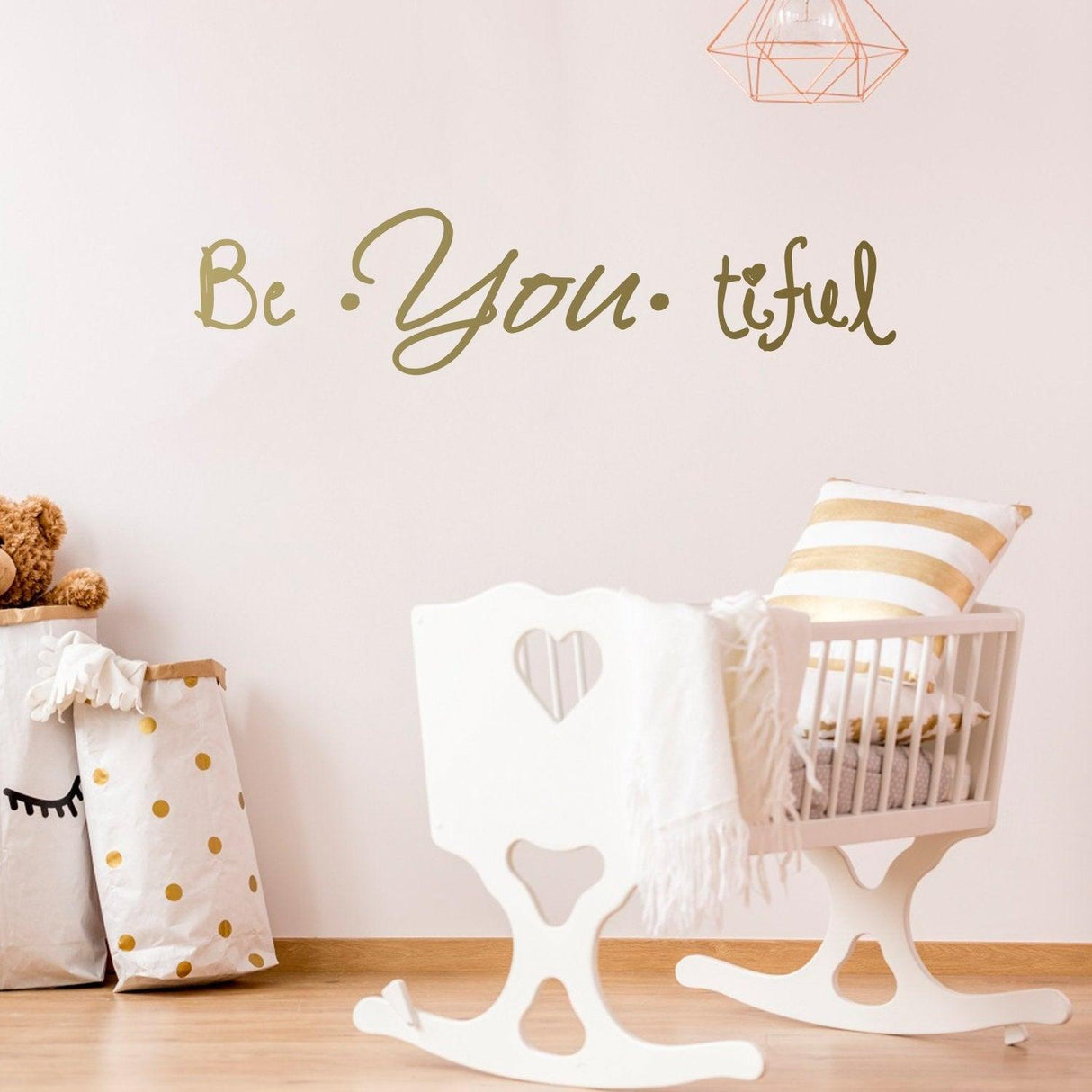 Beautiful wall sticker saying 'Be You tiful' in a stylish nursery setting with a rocking chair and teddy bear.