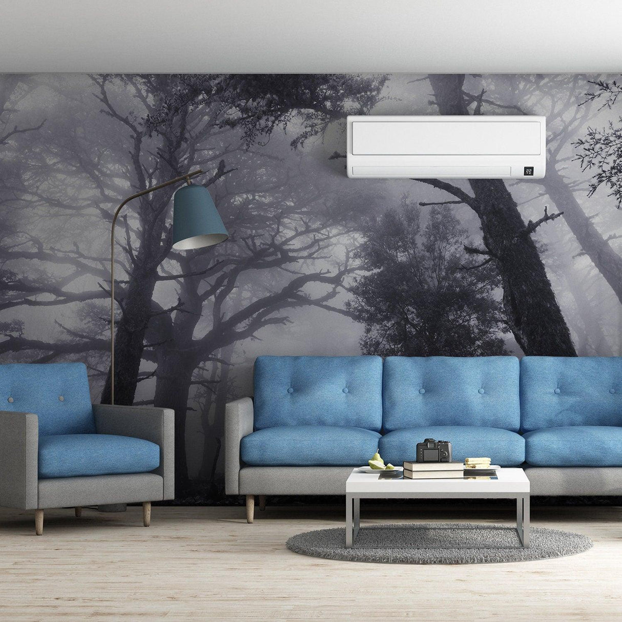 Foggy forest mural wallpaper in a modern living room with blue sofas and a stylish lamp.