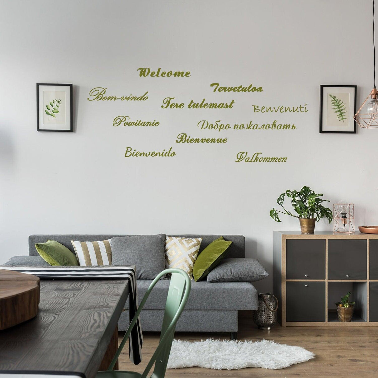 Welcome vinyl wall stickers in various languages displayed in a stylish living room setting.