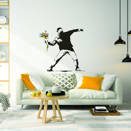 Banksy Flower Throw wall vinyl sticker decor in modern living room with stylish sofa and bright cushions.