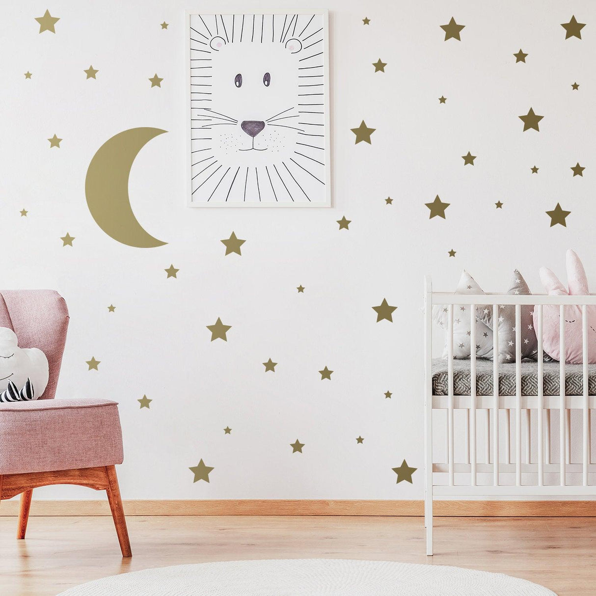 Nursery decor featuring star wall stickers and crescent moon decal above a crib with lion art.