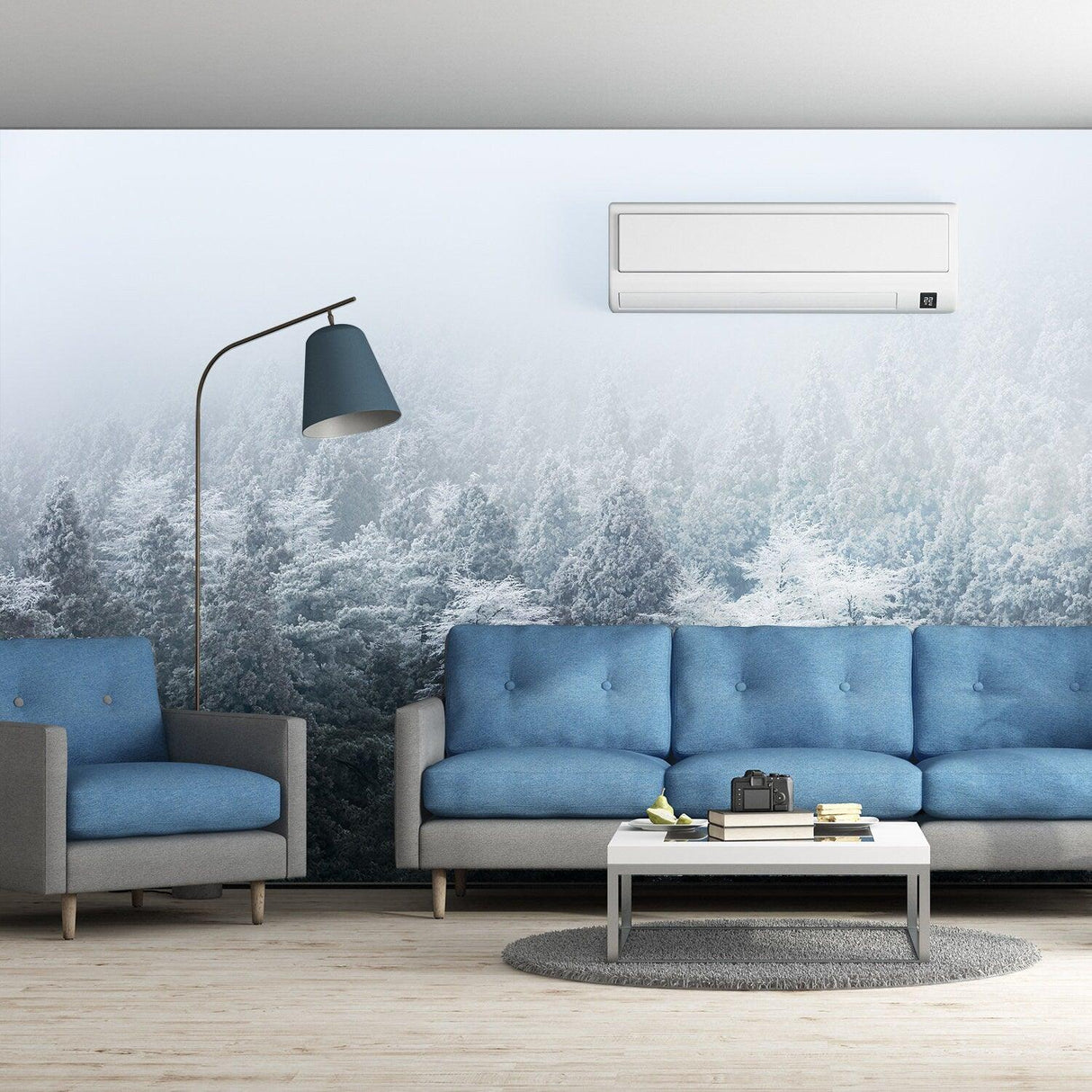 Living room with Foggy Forest Wallpaper Sticker Mural featuring mountain trees and fog, blue furniture, and modern decor.