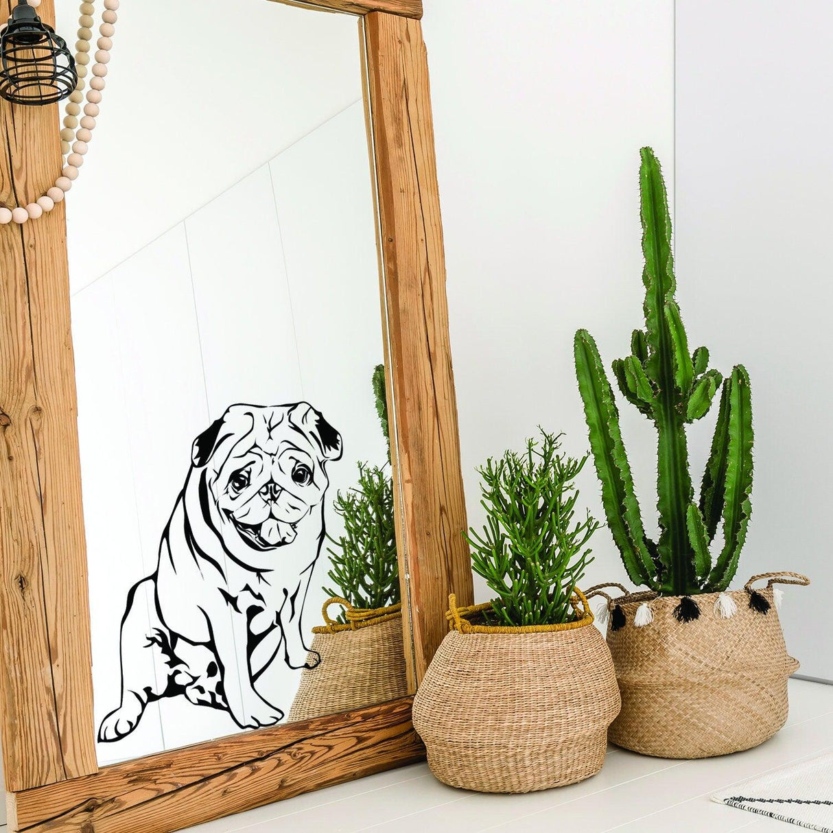 Custom wall decal of a pug on a mirror, surrounded by plants and a wooden frame, showcasing a pet's likeness.