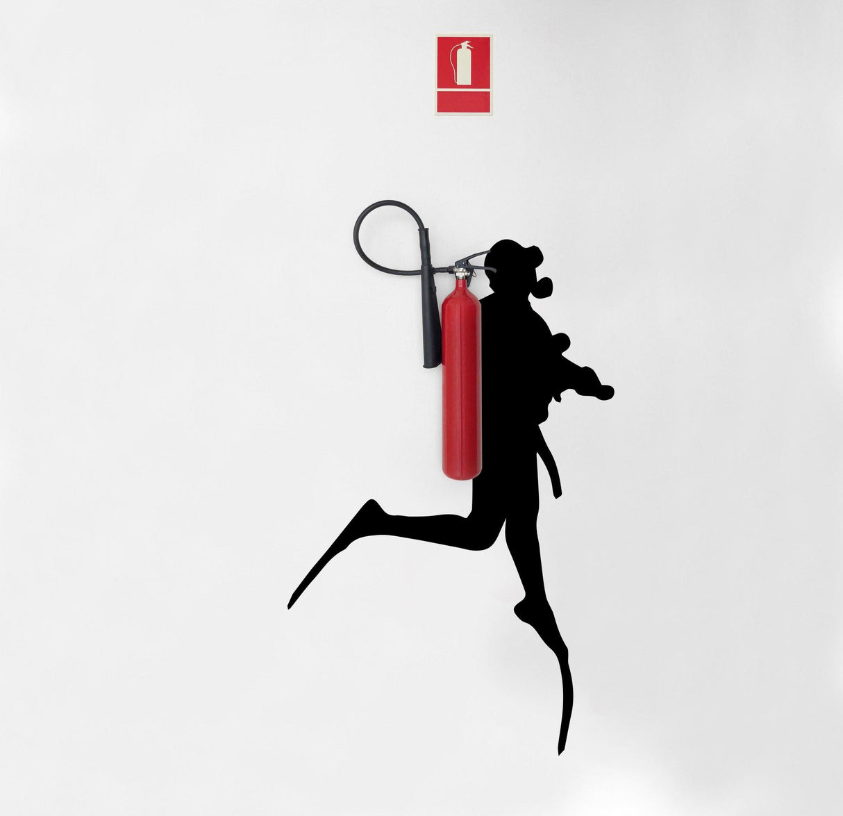Silhouette of a scuba diver running with a fire extinguisher wall sticker on a white background.