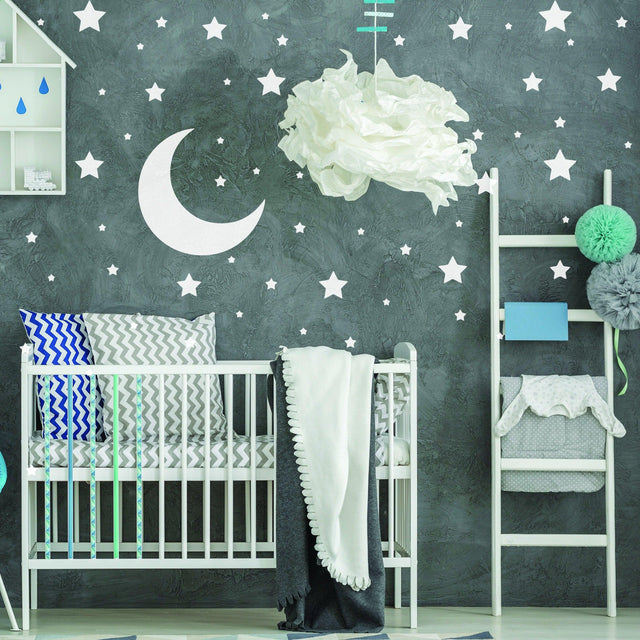 Nursery featuring 233x white stars wall vinyl stickers and moon decal on a dark wall with a crib and decorative elements.