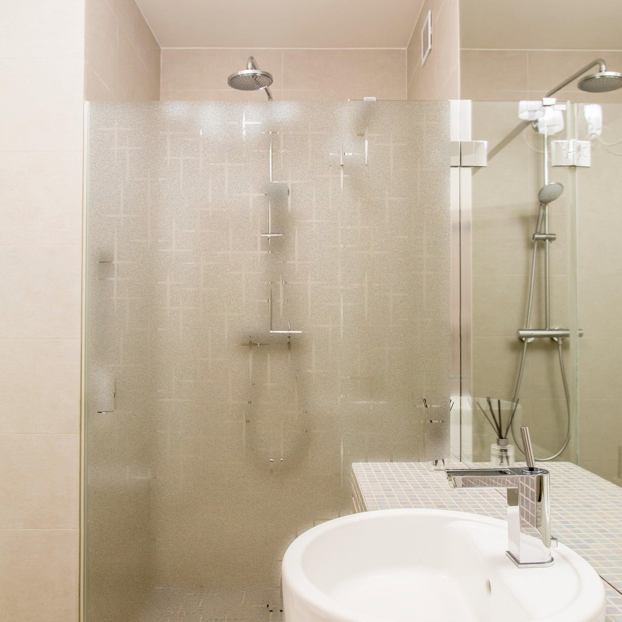Modern bathroom with frosted shower glass, sleek fixtures, and elegant tile design, showcasing minimalist style.
