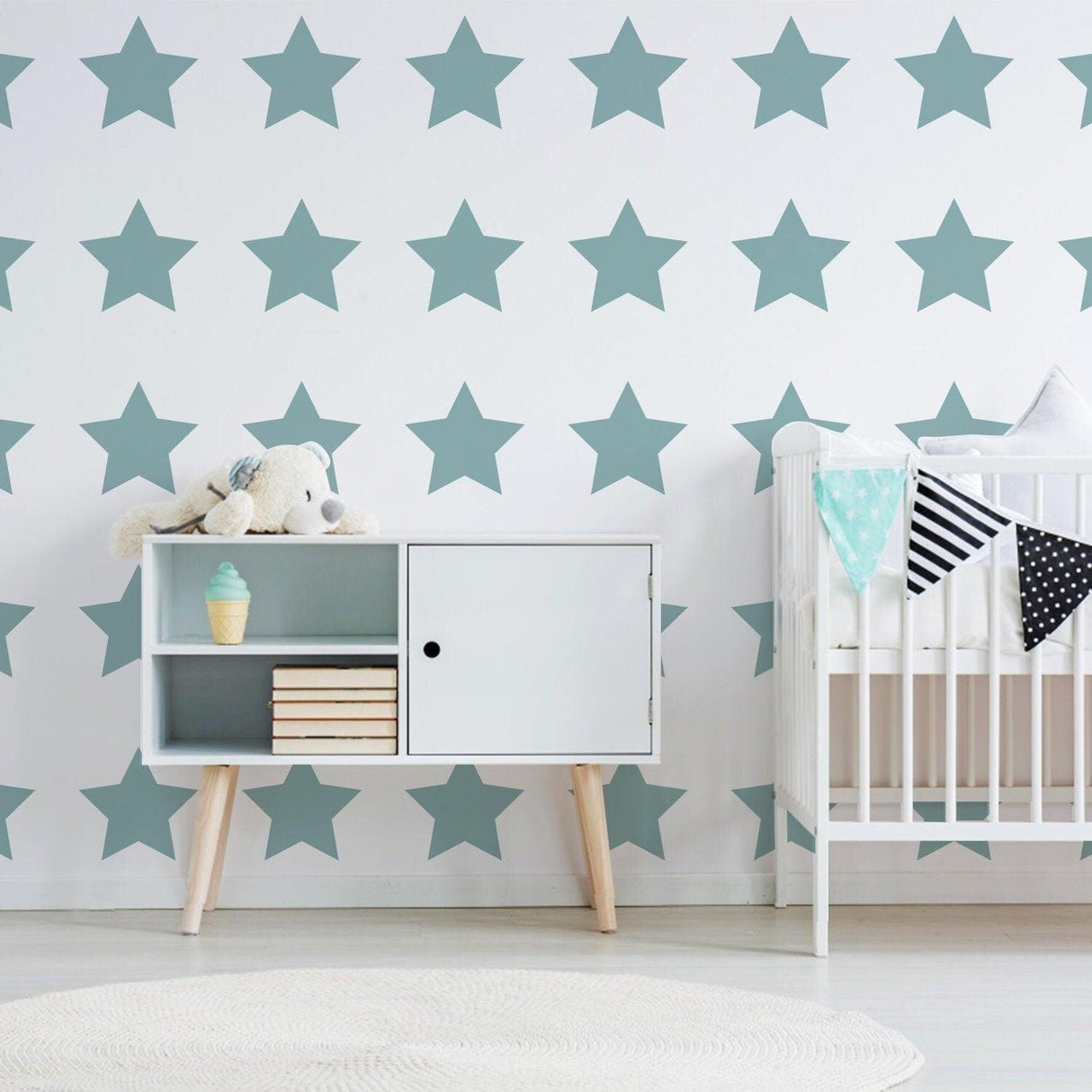 Baby nursery featuring mint green star wall decals and stylish furniture, perfect for baby shower decor.