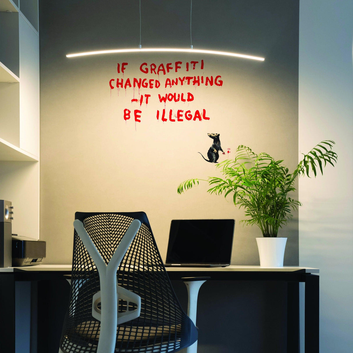 Banksy Illegal Rat Vinyl Wall Sticker on a wall with the quote "If graffiti changed anything - it would be illegal" in a modern home office.
