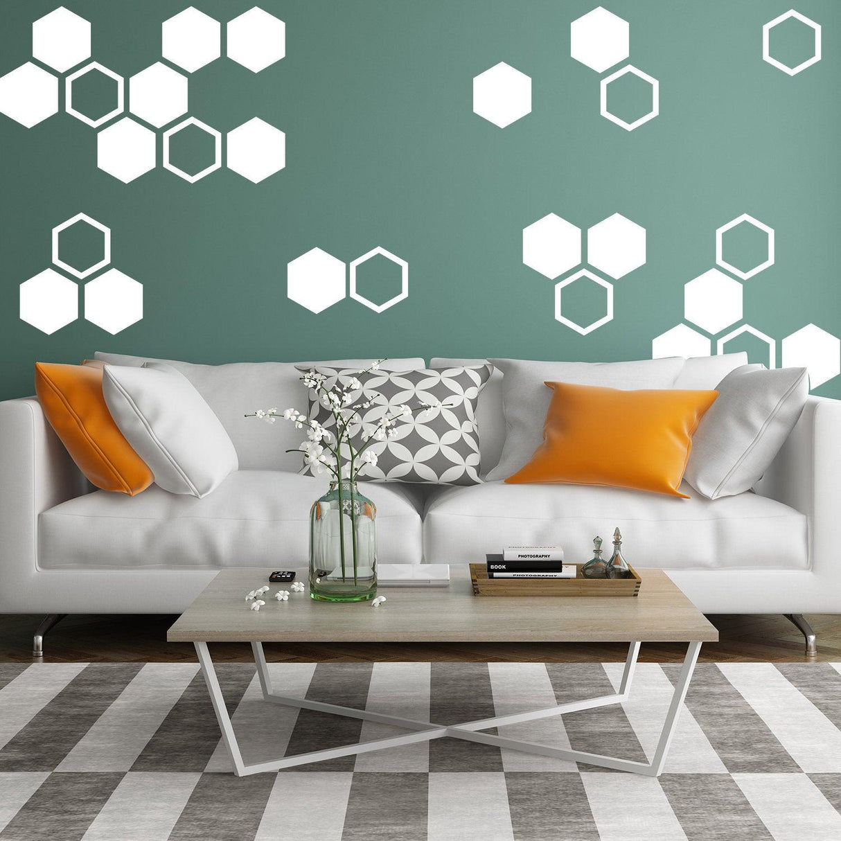 Modern honeycomb wall decals in white against a green wall, enhancing a stylish living room with a gray and orange color scheme.
