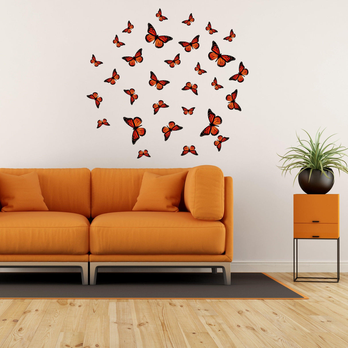 Colorful butterfly wall decor stickers arranged above an orange couch in a stylish living room.