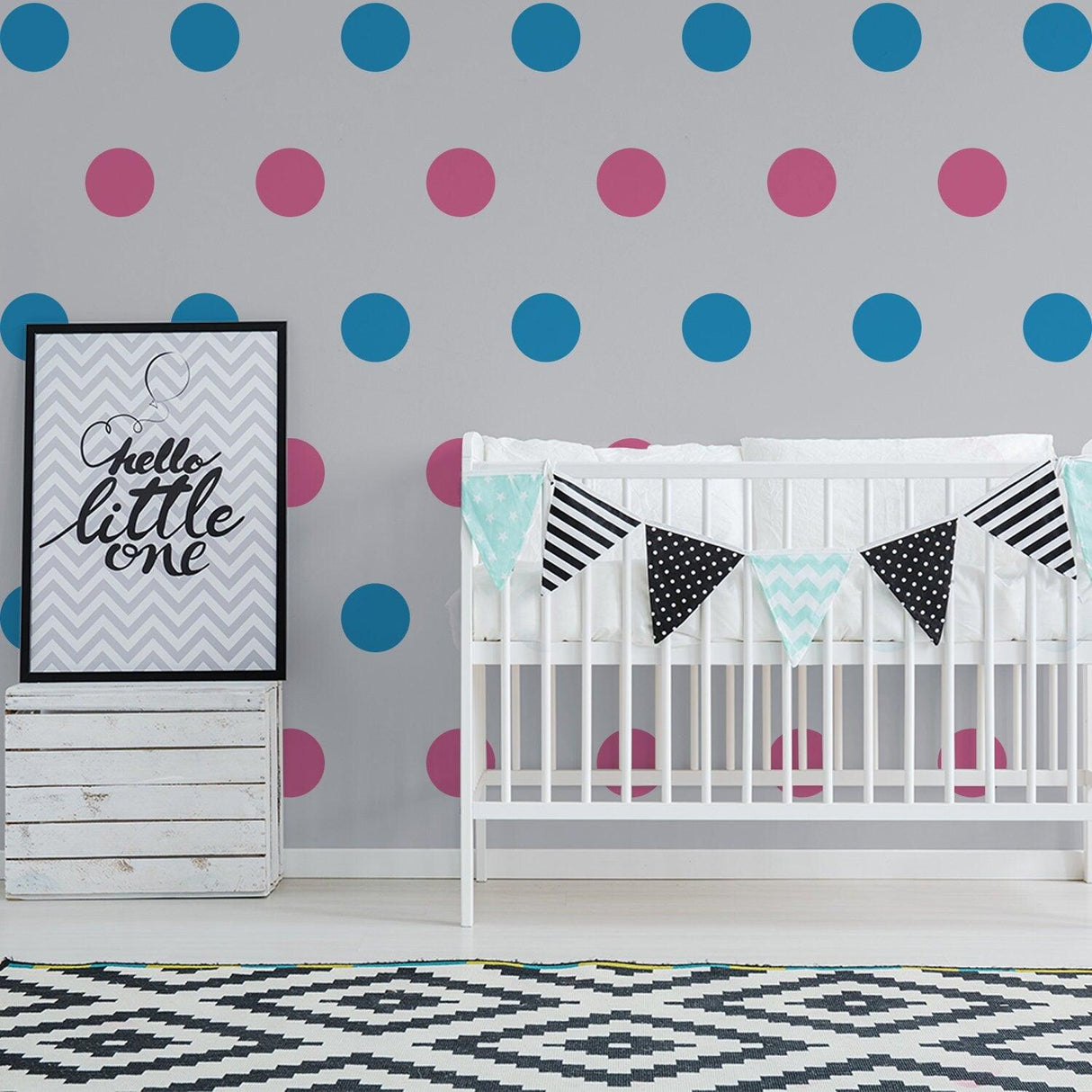 Nursery room featuring colorful wall dots, a crib with bunting, and cheerful decor for kids' space.