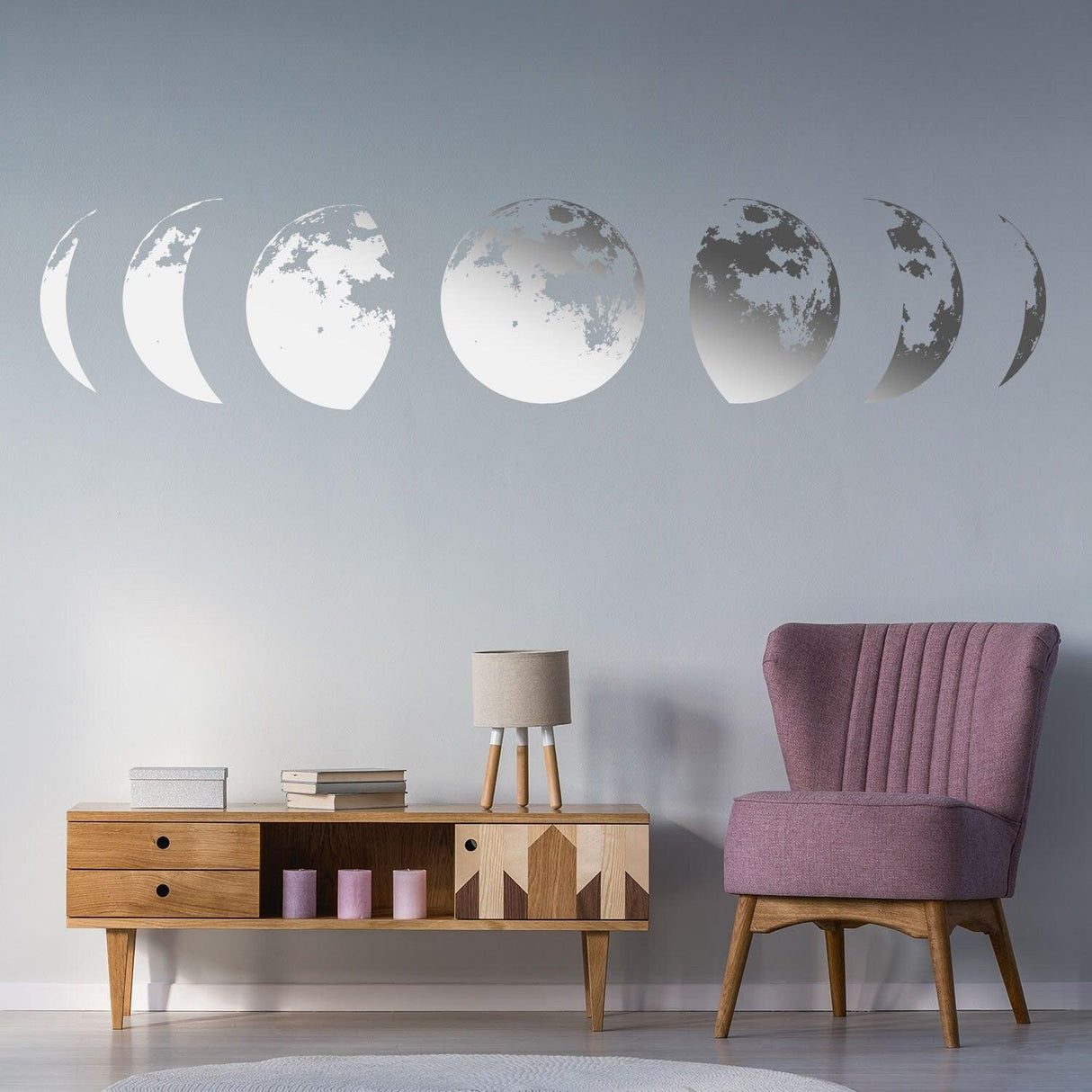 Moon phases wall decor decal in a stylish living room with pink chair and wooden furniture.