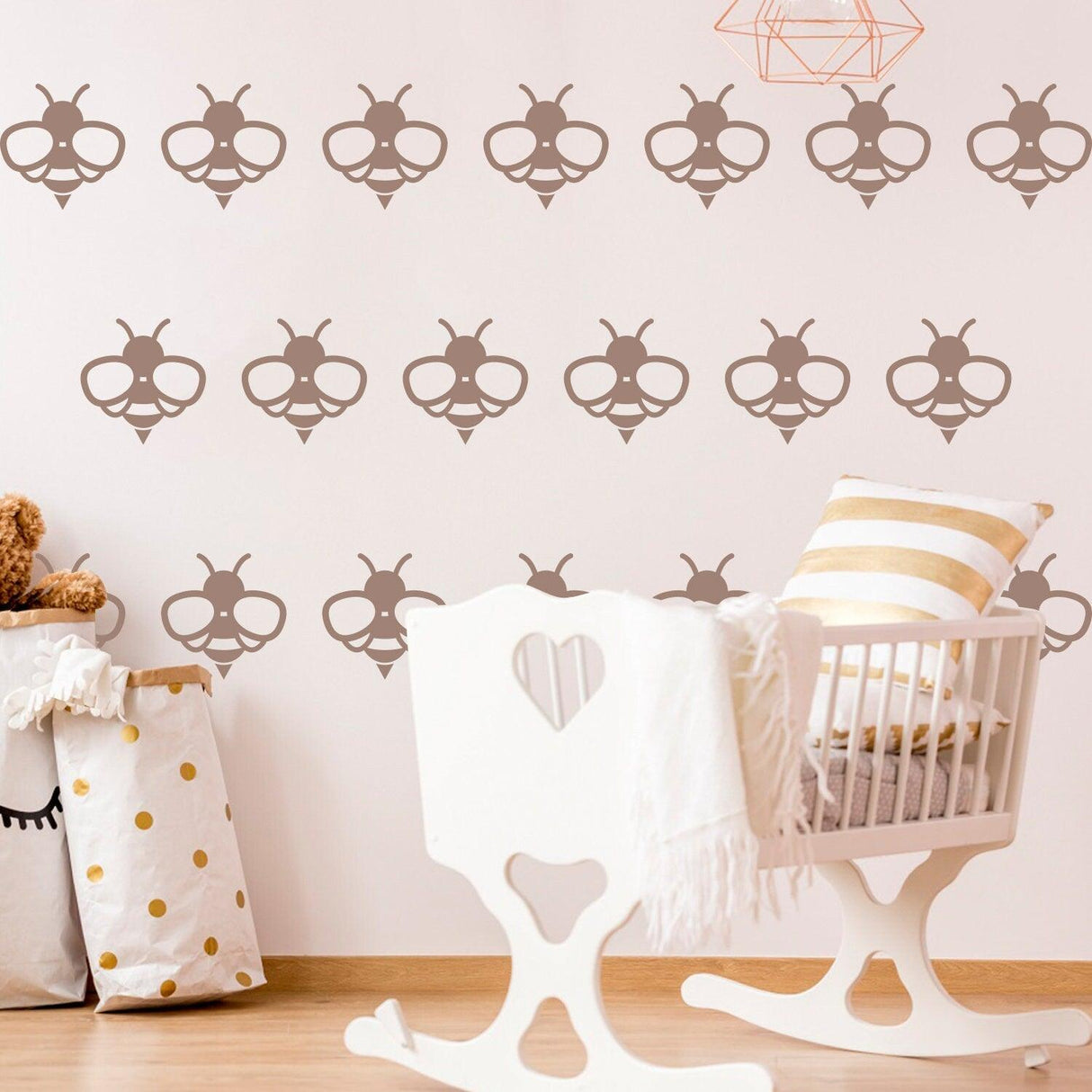 Decorative bee wall stickers in a nursery with a rocking chair and plush toys, perfect for playful, nature-inspired decor.