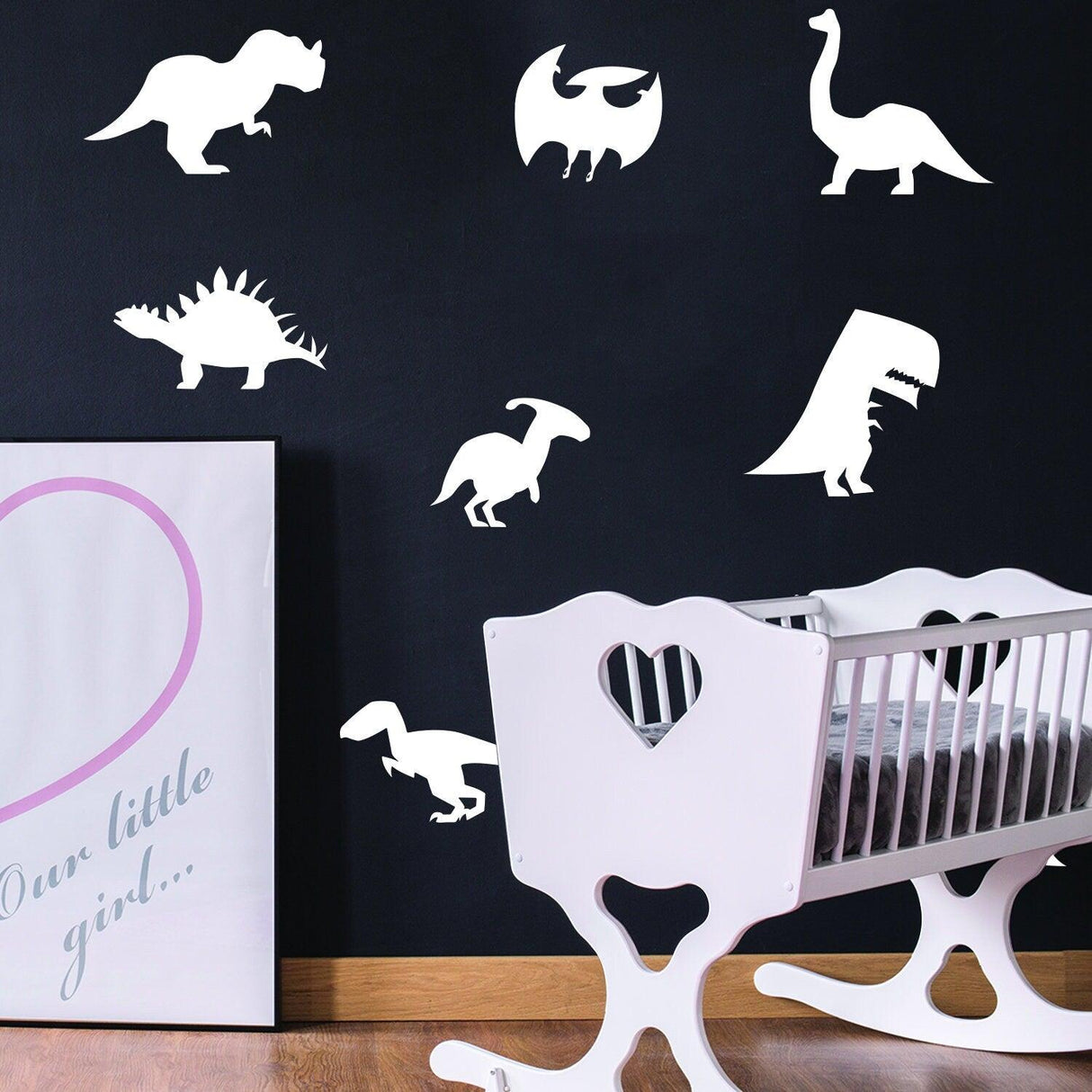 Glow in dark dinosaur wall decals in a child's room, featuring various dinosaur silhouettes on a black wall.