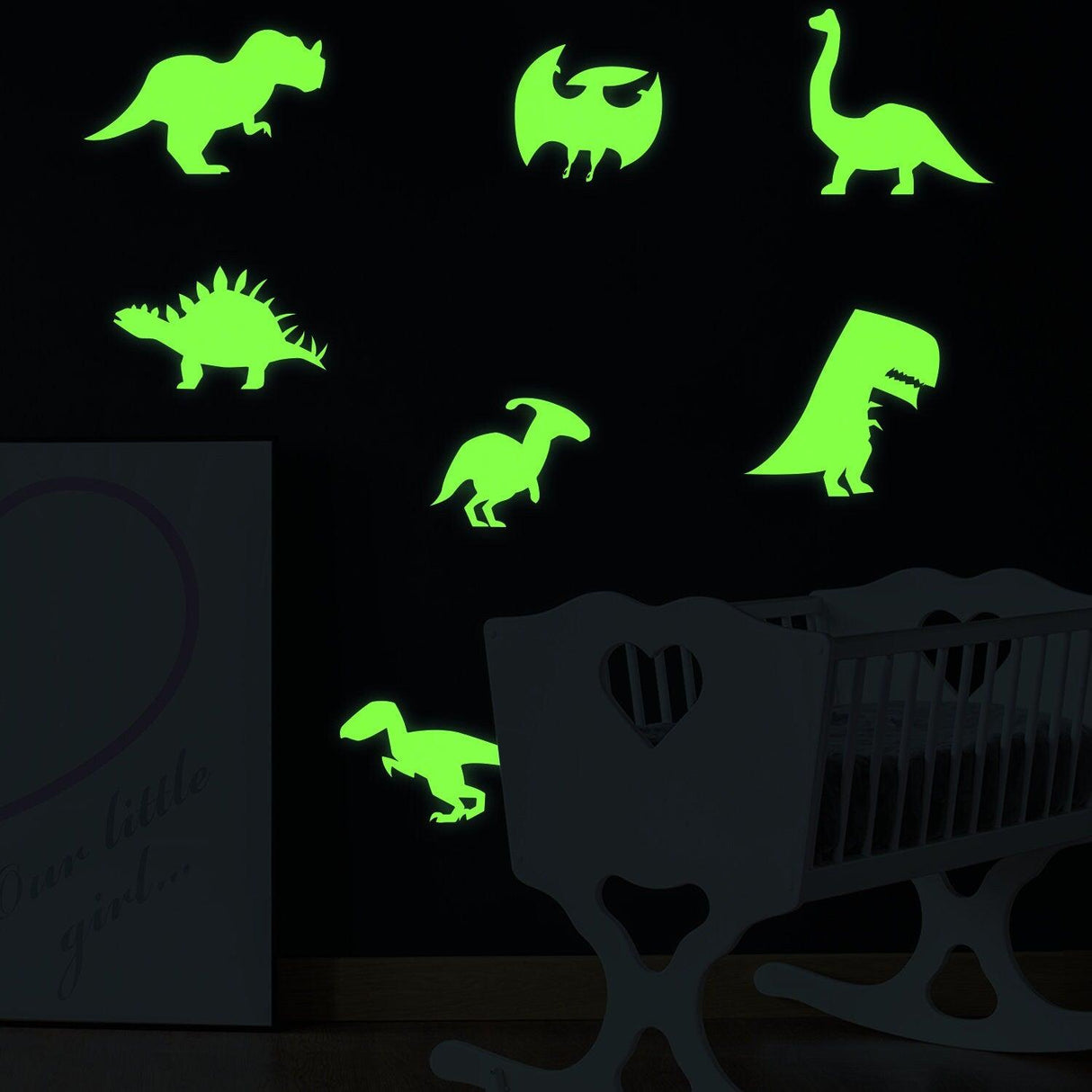Glow in dark dinosaur wall decals in vibrant green on black wall, perfect for kids' room decor.