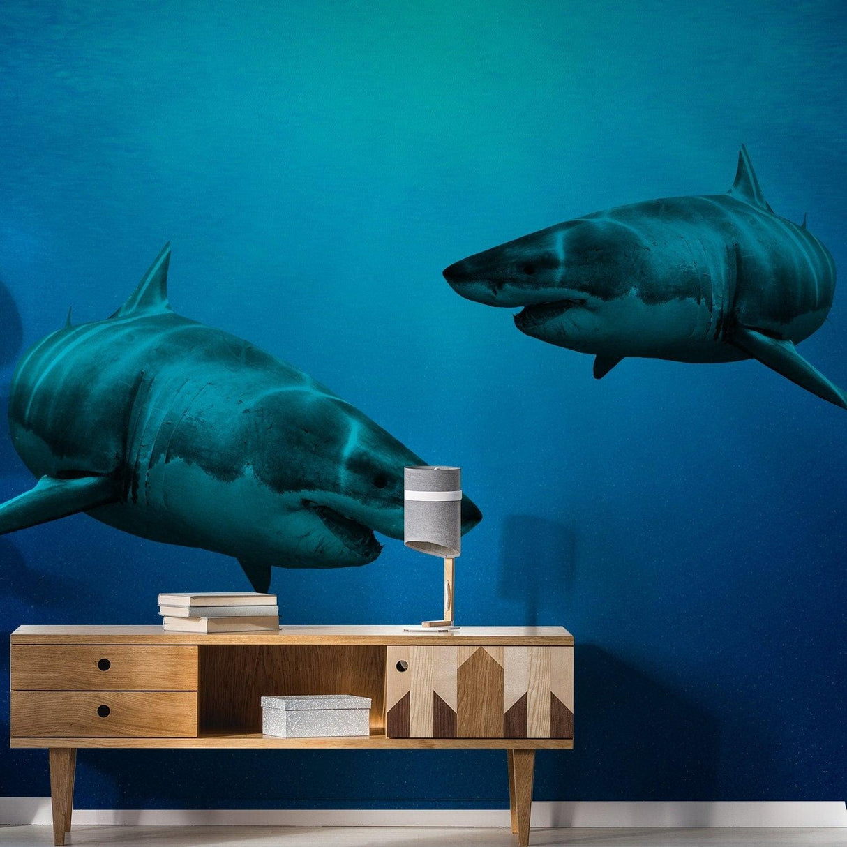 Two realistic 3D shark stickers swimming in a blue underwater scene on a living room wall.