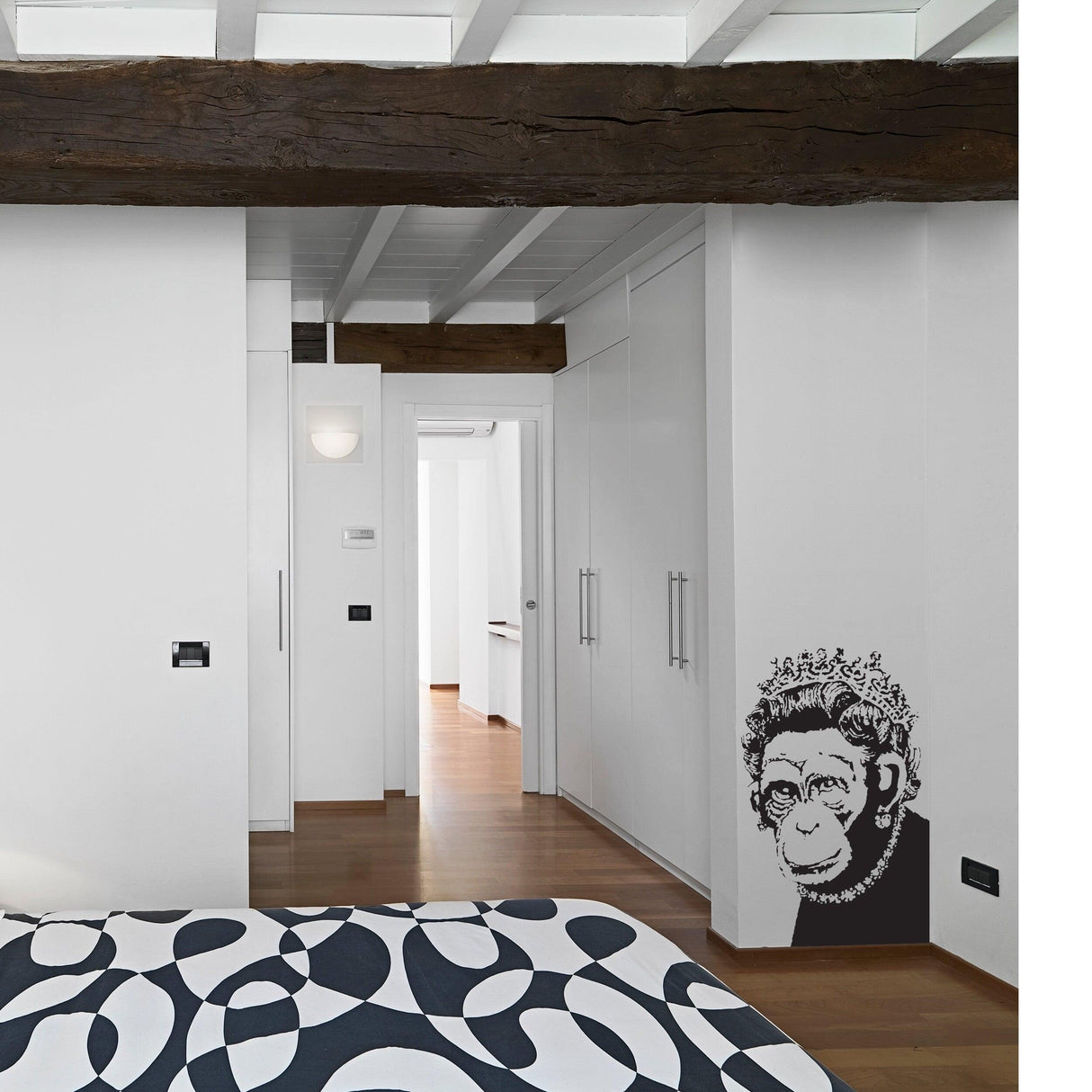 Banksy-inspired monkey wall art sticker in modern bedroom decor, adding humor and positivity.