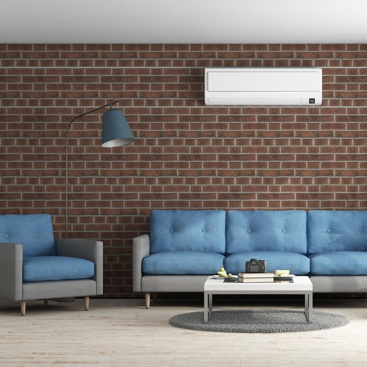 Living room featuring brick self-adhesive wallpaper with blue sofas and modern decor elements.