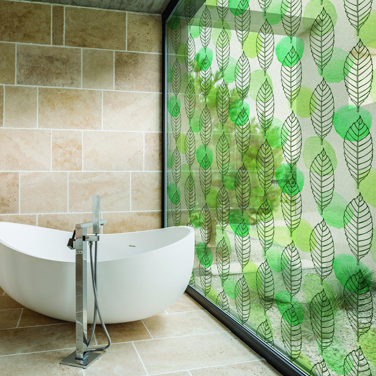 Leaf window privacy glass film with frosted design in modern bathroom featuring freestanding tub.