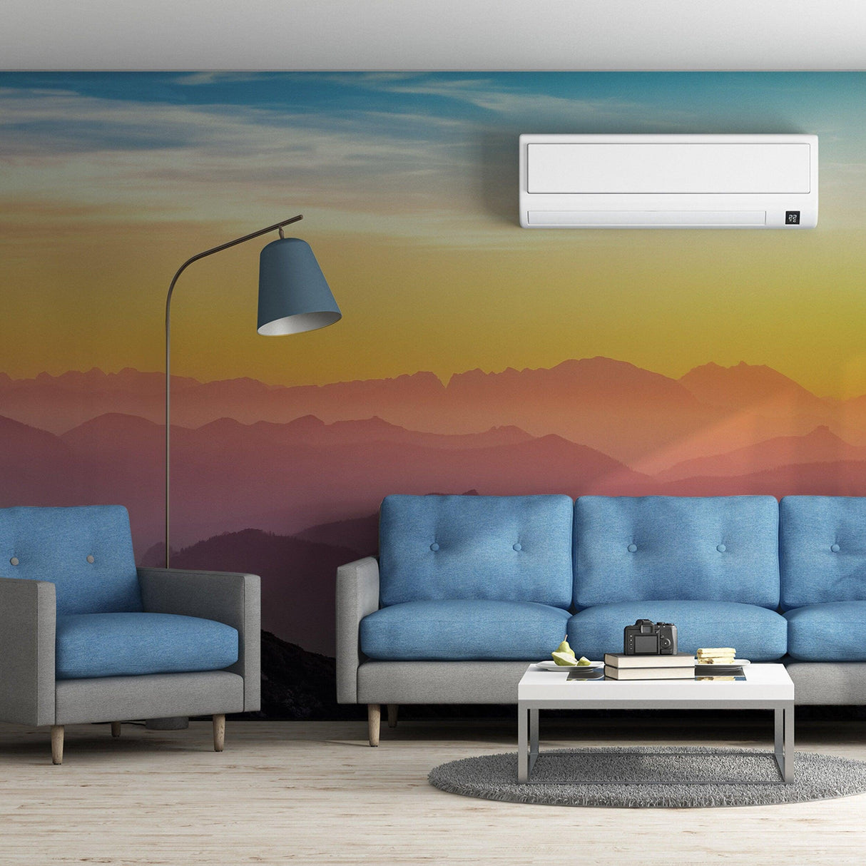 Sunset wallpaper mural in a modern living room with blue sofas and stylish lamp.