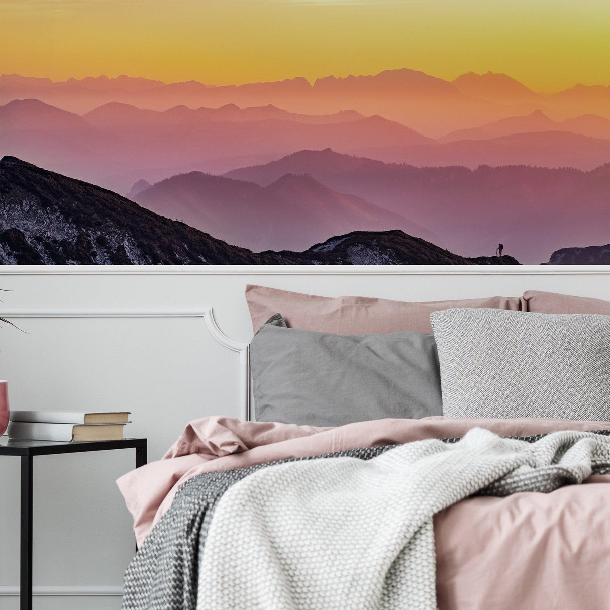 Serene sunset wallpaper decal featuring vibrant mountain silhouettes in a cozy bedroom setting.