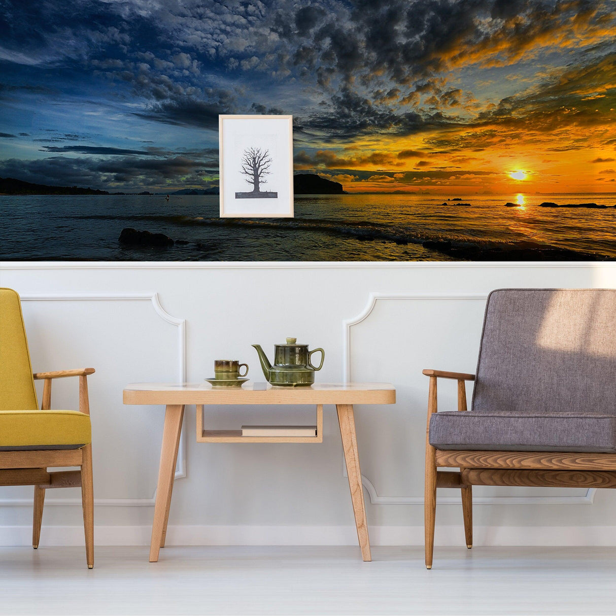Stylish living room featuring sunset wallpaper decals, modern furniture, and serene coastal view.