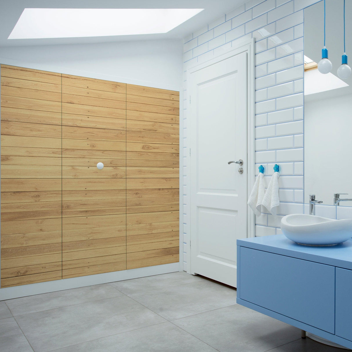 Modern bathroom featuring Shiplap Peel and Stick Wallpaper, light wood wall, and blue vanity and fixtures.