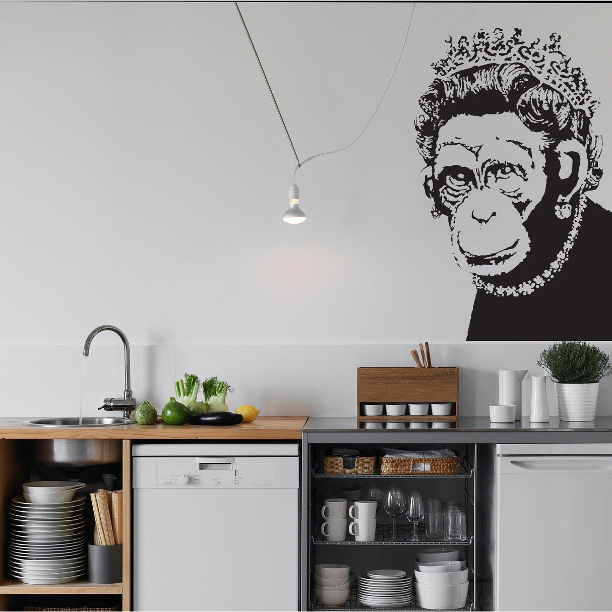 Banksy Monkey Queen Wall Art Sticker in modern kitchen decor, featuring a playful monkey with a crown.