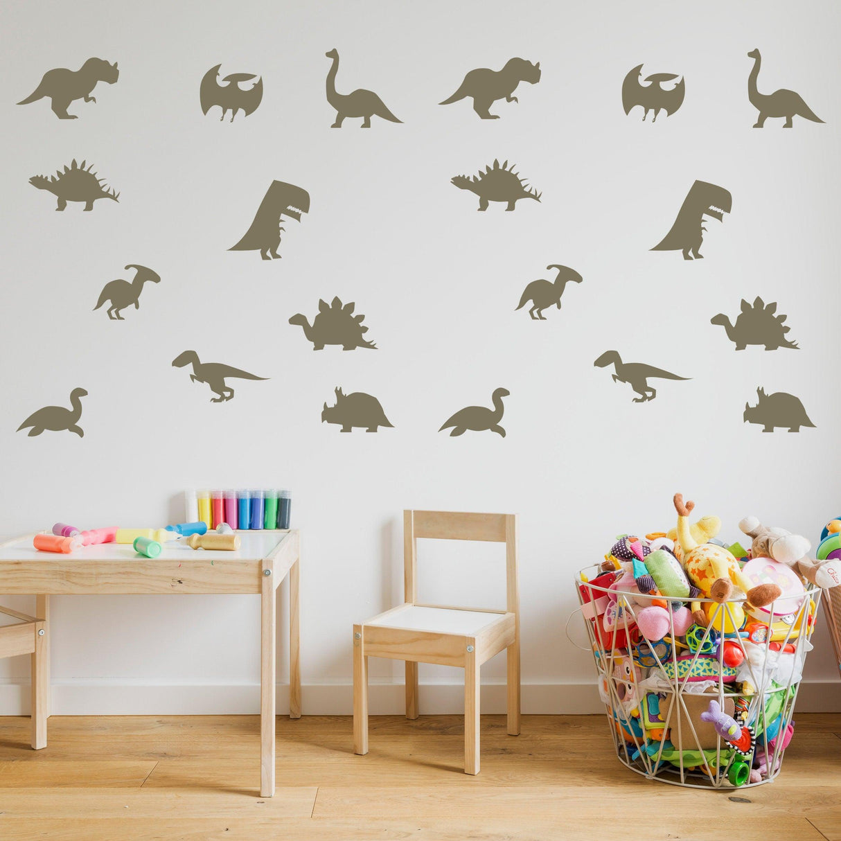 Dinosaur silhouette wall decals in a nursery with colorful toys and furniture, perfect for baby room decor.