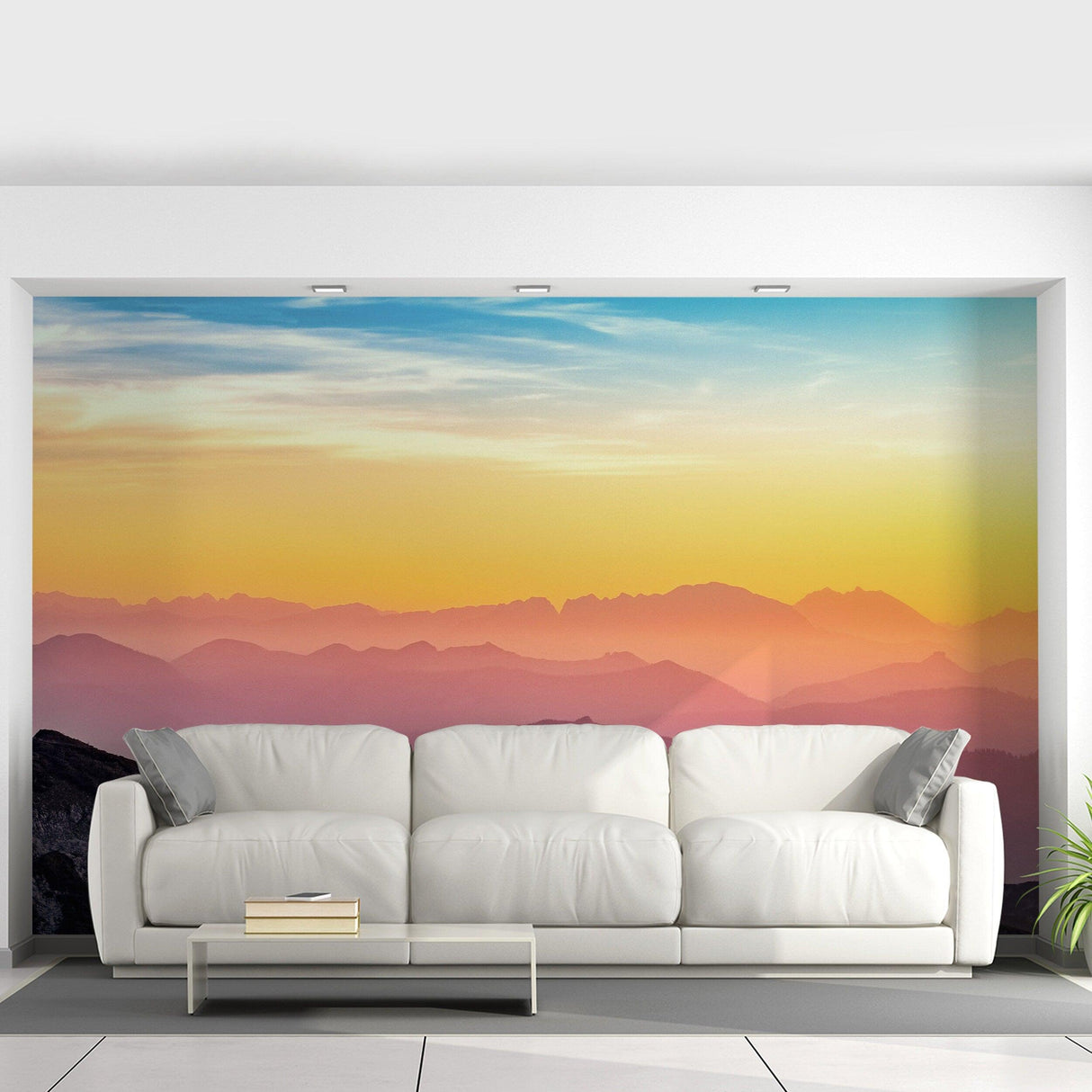 Modern living room with white sofa and sunset mural wall decals, creating a serene atmosphere.