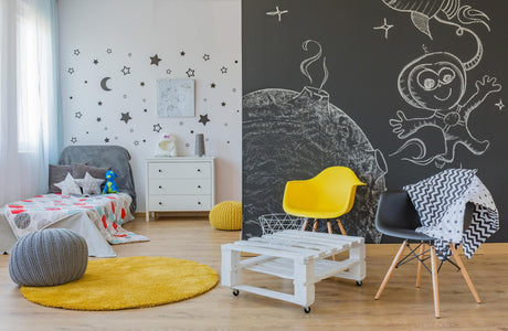 Brightly decorated children's room featuring chalkboard wall art, colorful furniture, and playful decor.