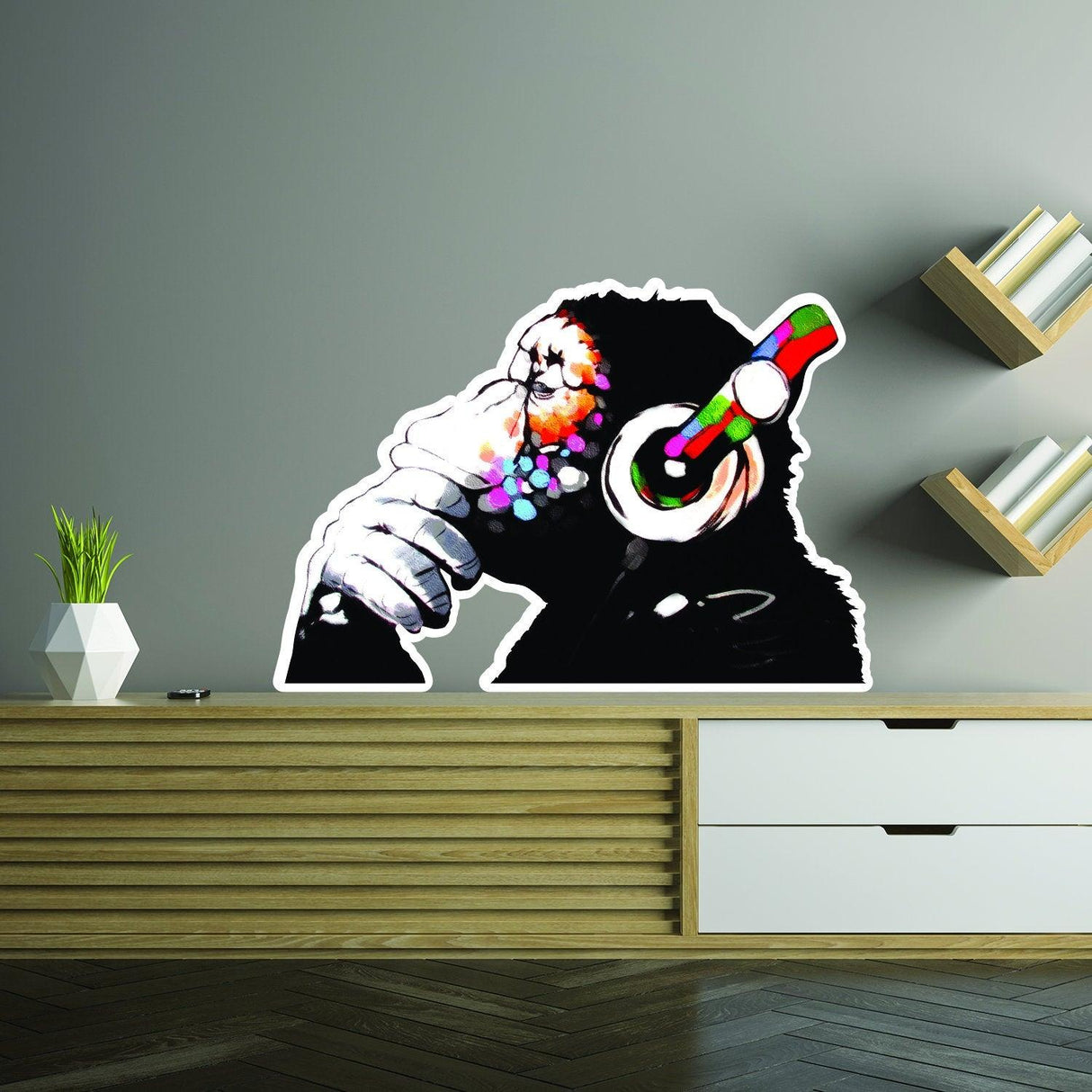 Banksy monkey with headphones wall sticker on a modern shelf, adding vibrant decor to any space.