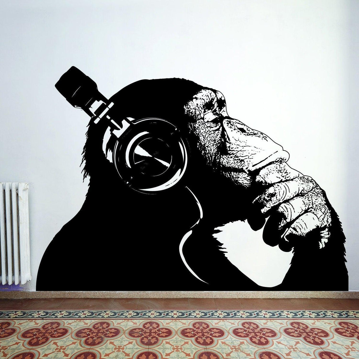 Black and white wall decal of a monkey with headphones, showcasing a thoughtful expression and modern design.
