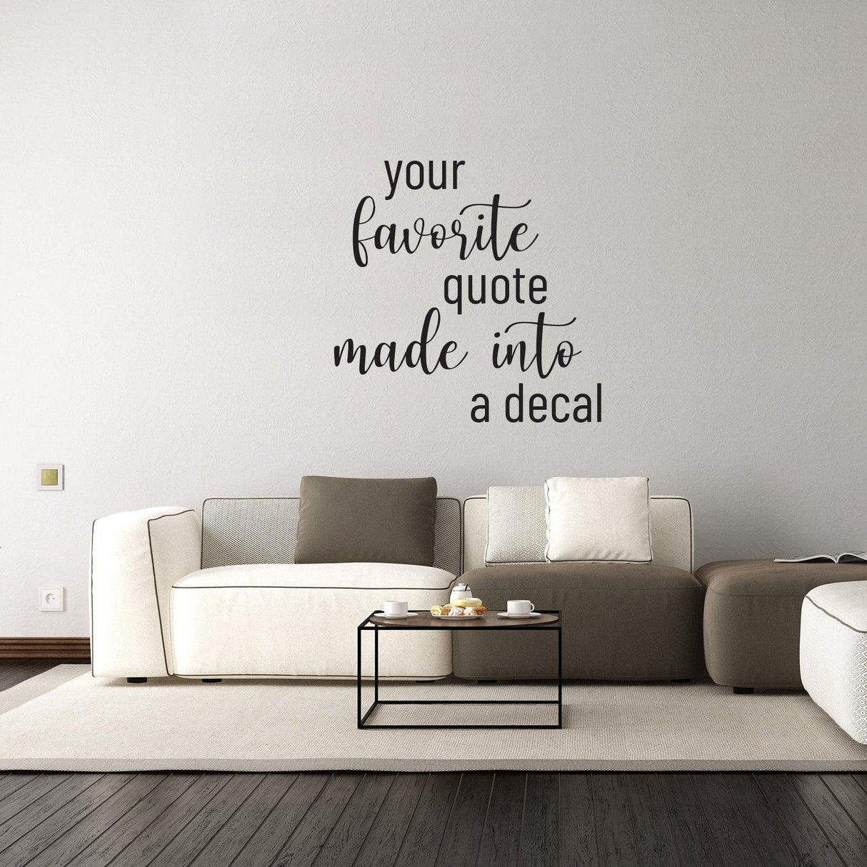 Personalized vinyl wall decal featuring the phrase 'your favorite quote made into a decal' above modern couch.