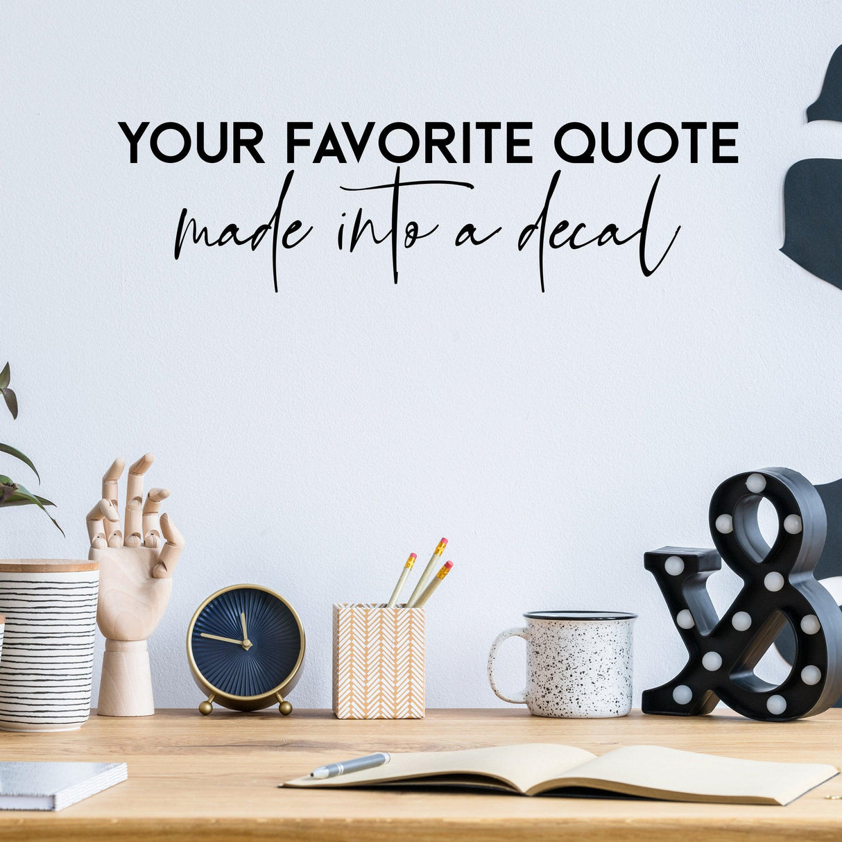 Custom vinyl lettering decal featuring the phrase 'Your Favorite Quote' on a stylish home office wall.