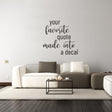 Custom vinyl lettering decal on a wall saying 'your favorite quote made into a decal' above a modern living room couch.