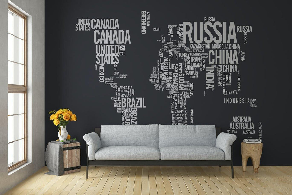 Modern living room featuring a world map wall decal made of country names.