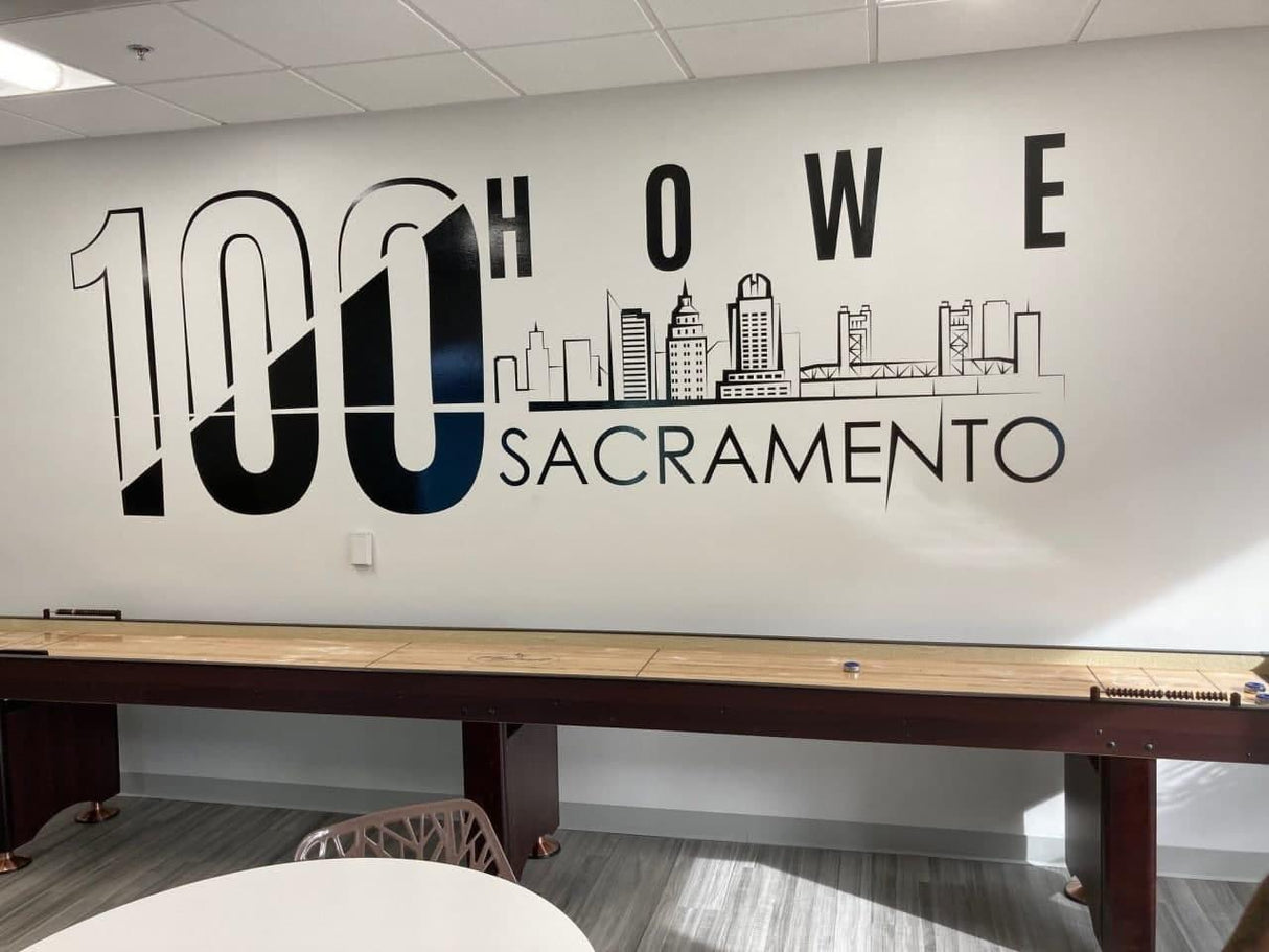 Wall decal featuring '100 Howe Sacramento' with a skyline design, showcasing modern interior decor.