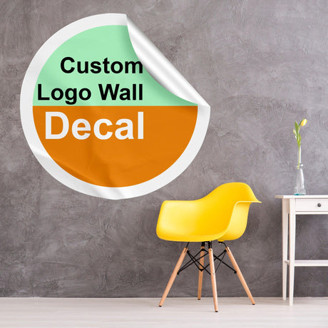 Custom logo wall decal in circular design on a textured wall with a yellow chair and vase.