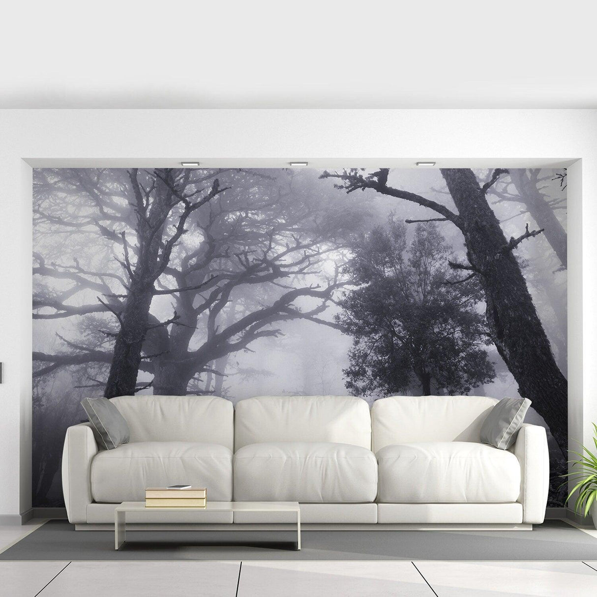 Foggy forest wallpaper mural in gray tones, enhancing a modern living room with a serene atmosphere.