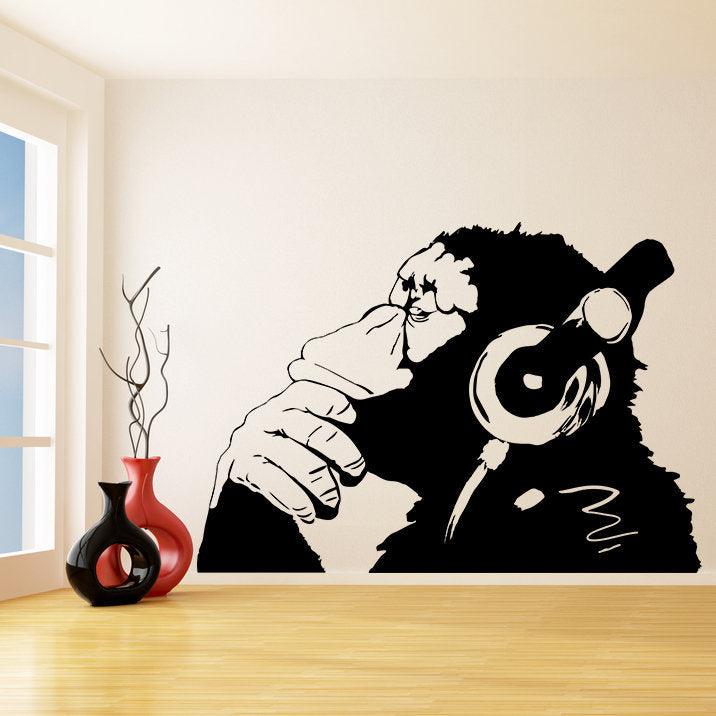 Banksy monkey wall sticker with headphones, featuring a thoughtful chimp decal in a stylish room.