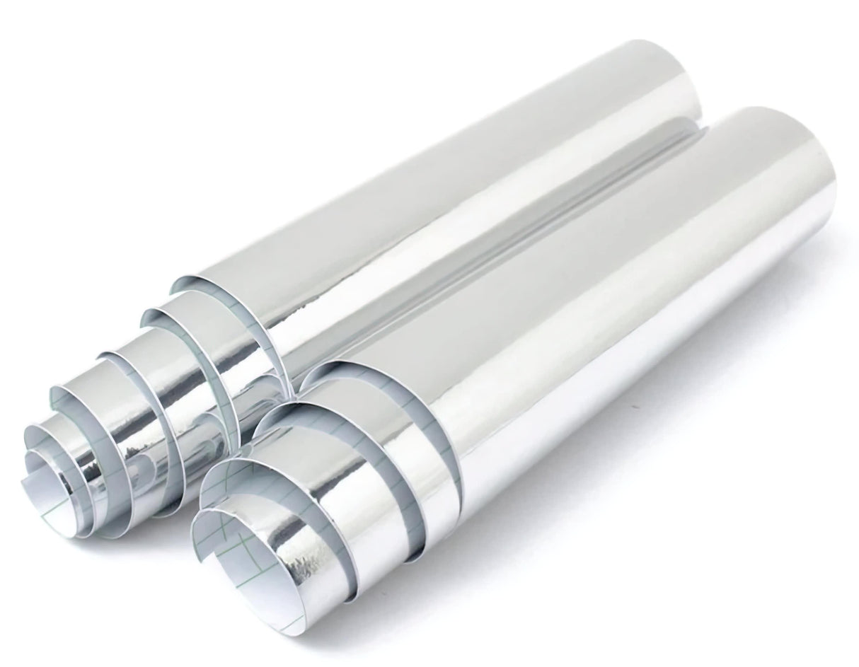 Two rolls of shiny silver chrome vinyl sticker wrap for car interiors, showcasing metallic mirror finish.