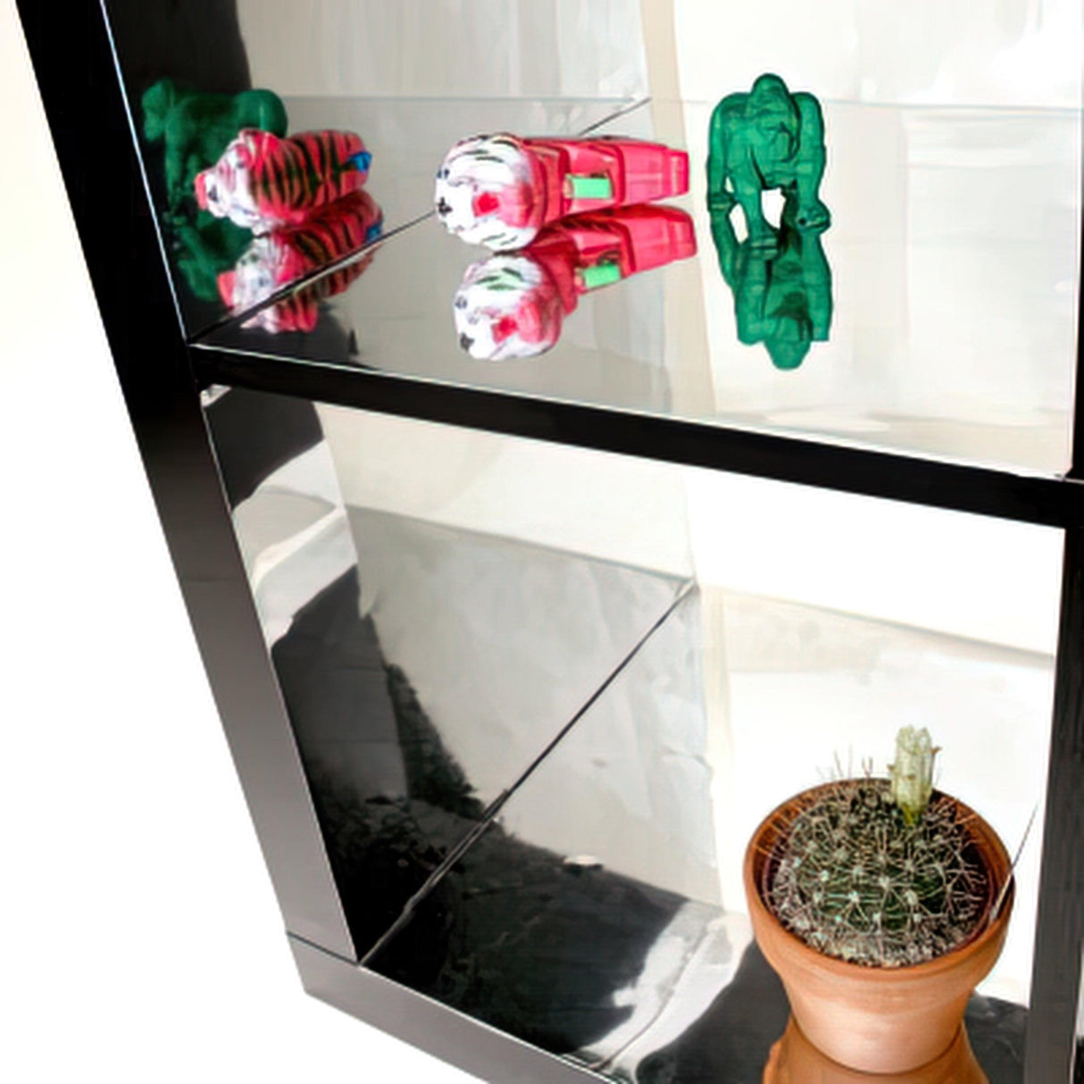 Silver chrome vinyl sticker wrap showcased on shelves with colorful toys and a cactus.