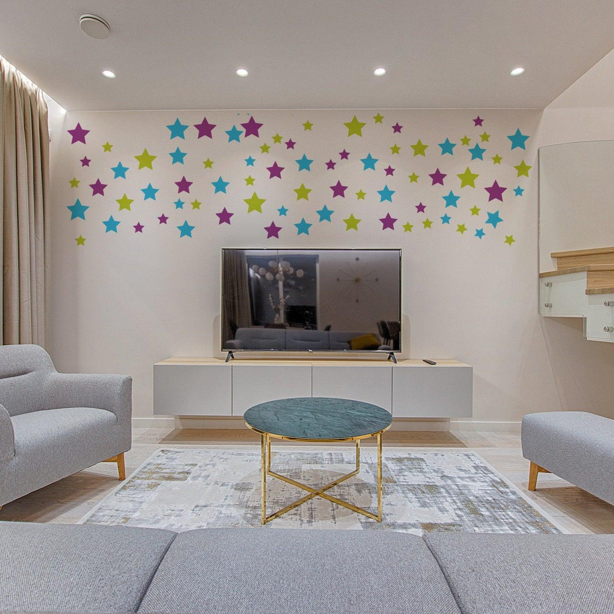 Decorative star wall decals in a nursery, featuring colorful stars above a modern TV stand.