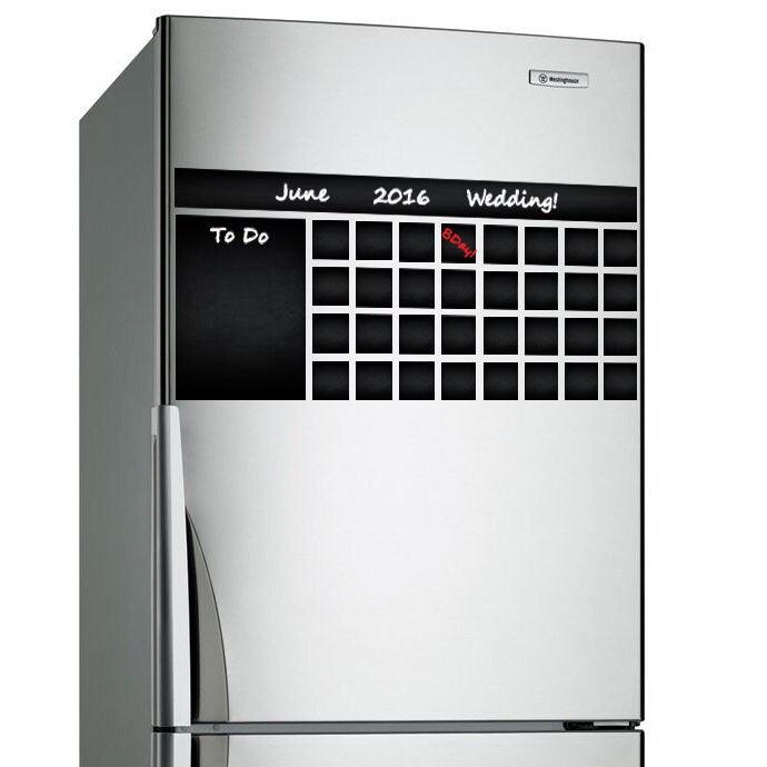 Blackboard decal wall planner on refrigerator displaying wedding event and to-do list for June 2016.