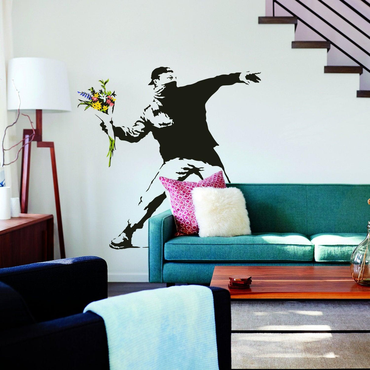 Banksy Flower Thrower wall decal in a modern living room, featuring graffiti-style art with vibrant colors.